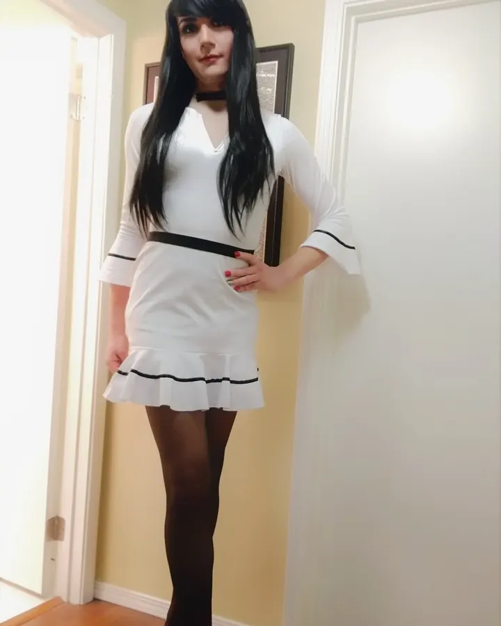 Mélanie en robe blanche courte et collants noirs